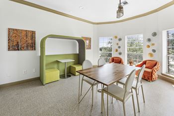 A dining room with a wooden table and chairs.